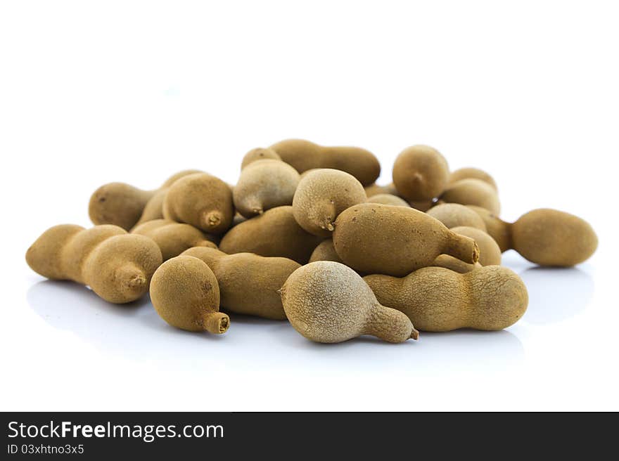 Sweet tamarind, exotic fruit, on white table