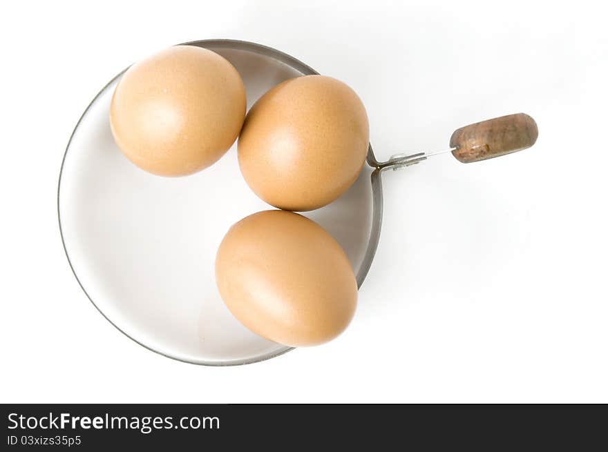 Eggs in kitchenware on white background