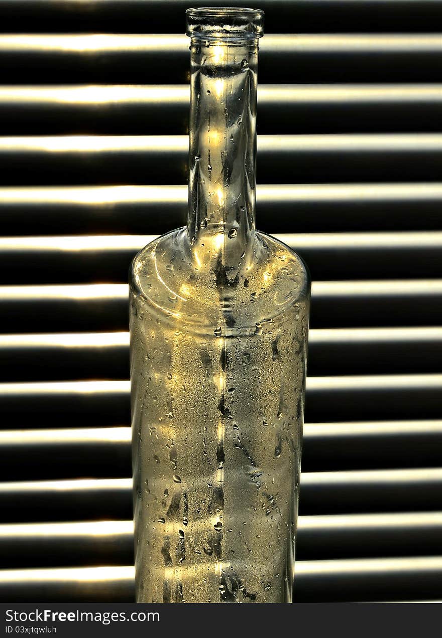 Glass bottle on window background