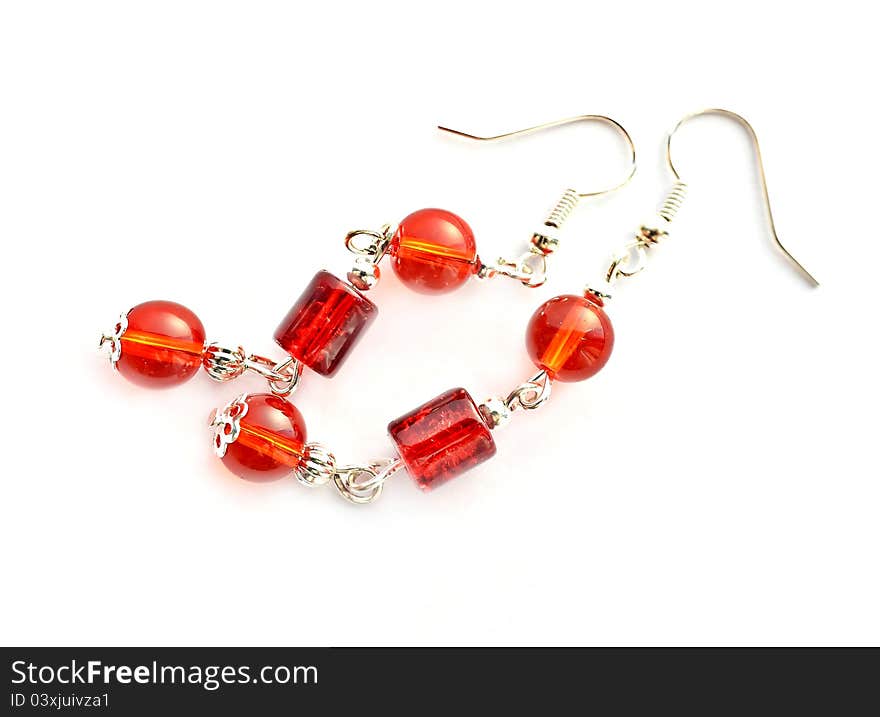 Red earrings on white background