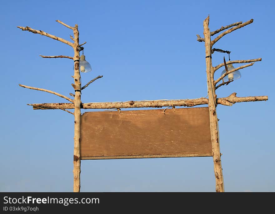 Blank wooden board on blue sky background