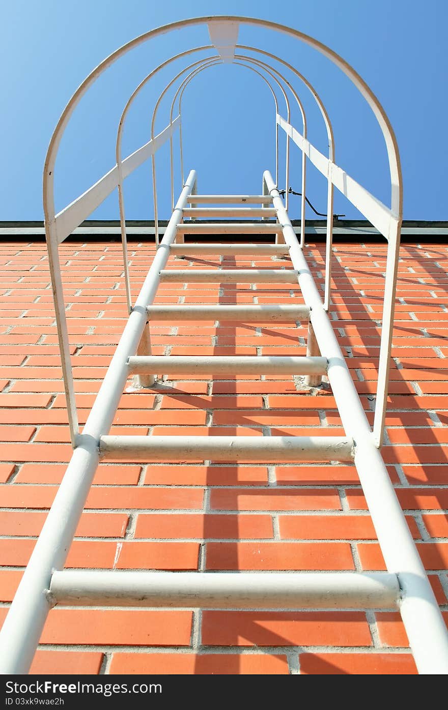 Metal ladder on the roof of an industrial building. Metal ladder on the roof of an industrial building