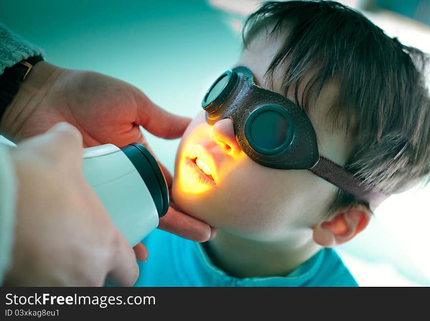 Close up portrait of a cute little boy during medical treatmant. Close up portrait of a cute little boy during medical treatmant