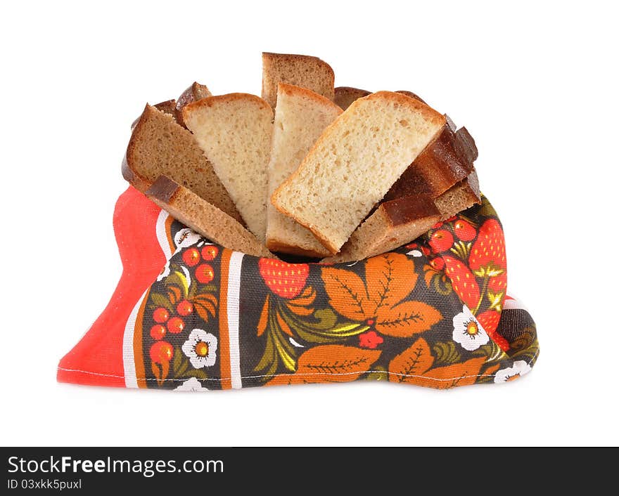 Pieces of wheaten and rye bread lay on a towel