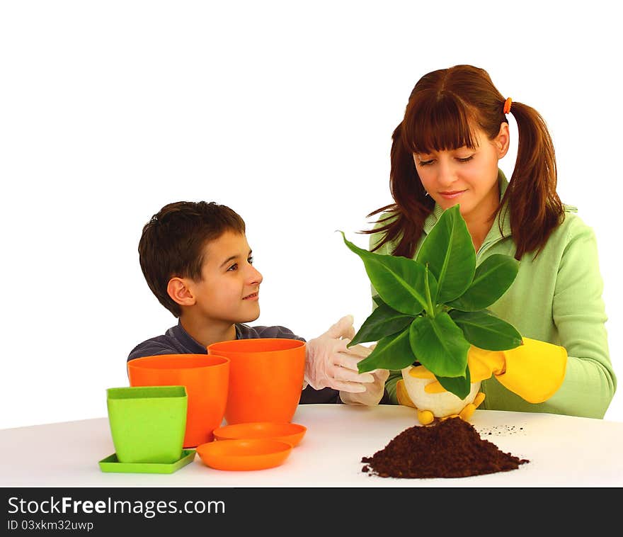 Mother and her son (boy, kid) planting a flower  isolated on a white background with different color flowerpots