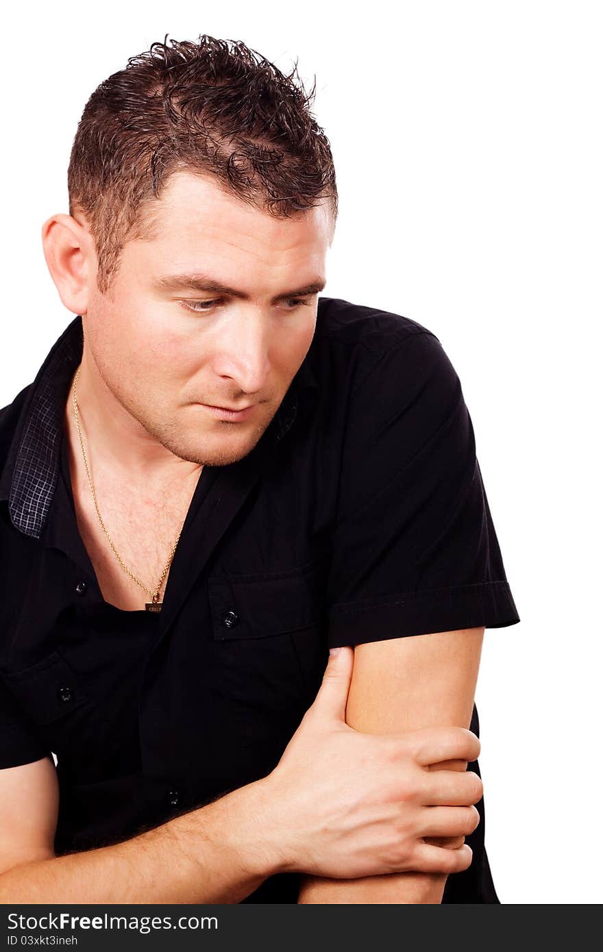 A young man in a black shirt, deep in thought on a white background. A young man in a black shirt, deep in thought on a white background