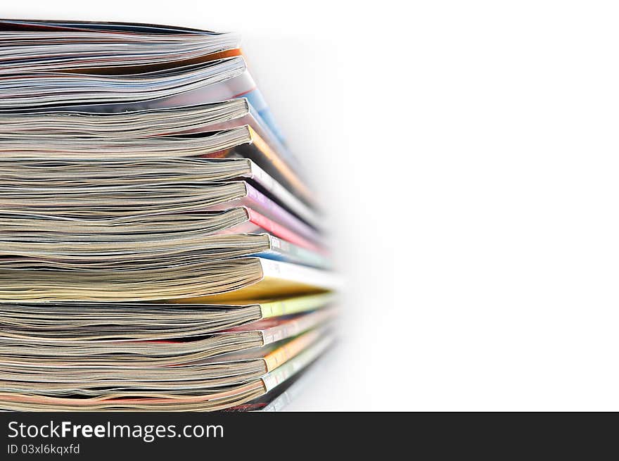 Pile of magazines on white background