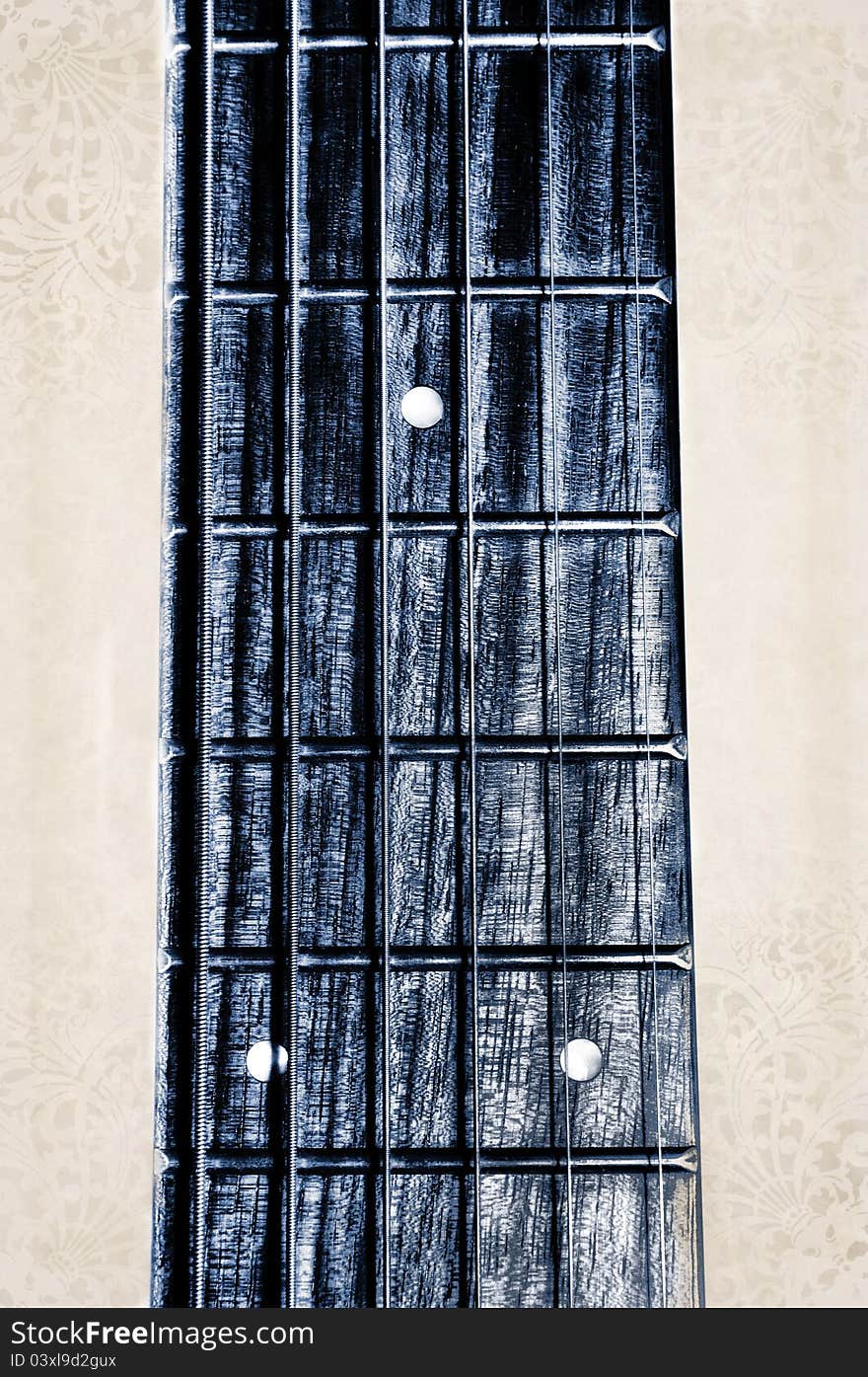 Acoustic guitar neck fingerboard on textured background