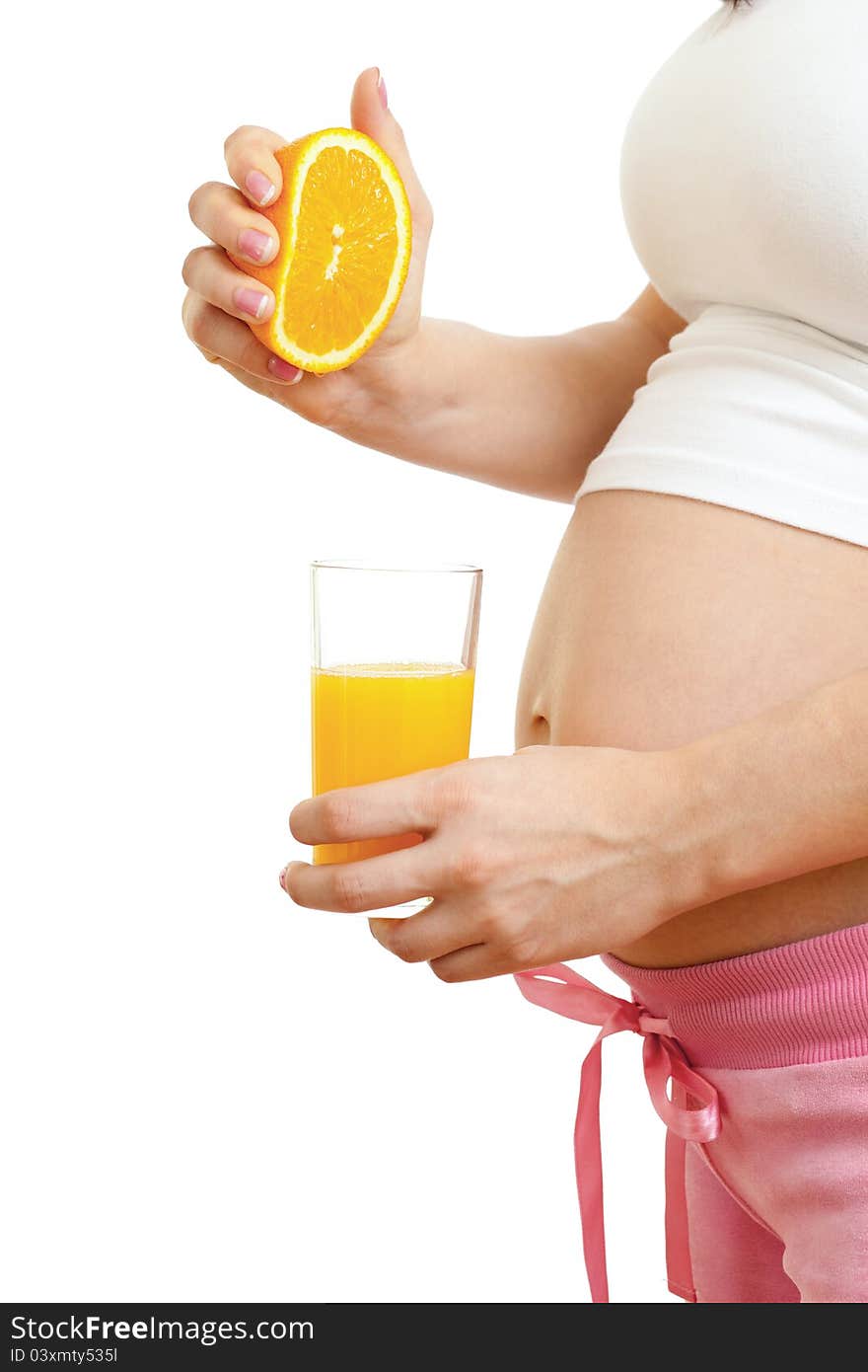 Pregnant woman drinking fresh orange juice isolated