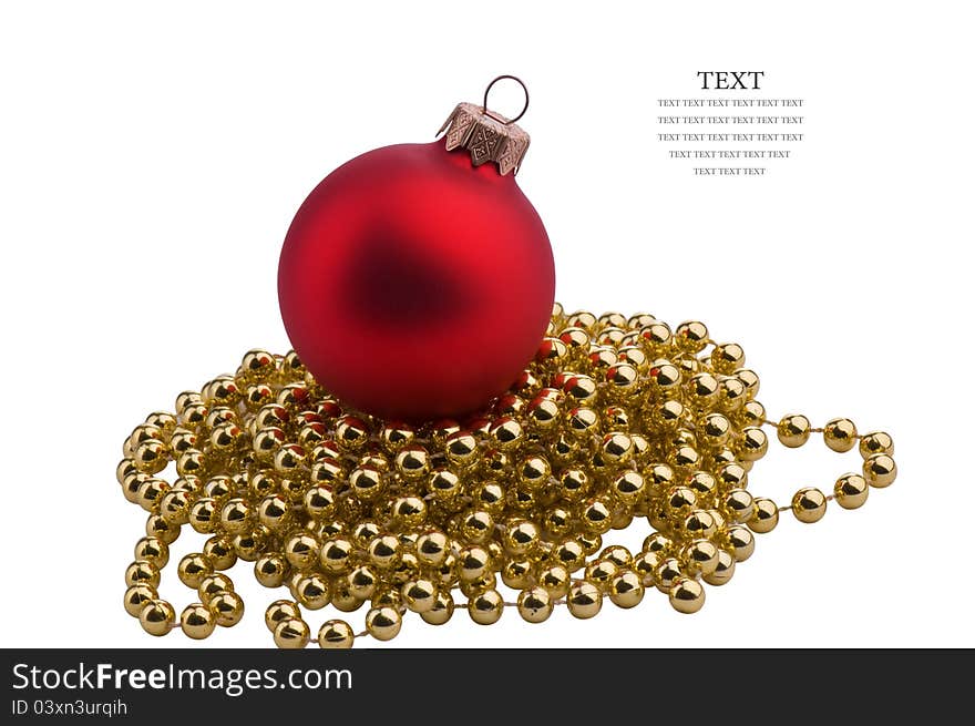 Christmas red sphere on a gold ornament for a pine