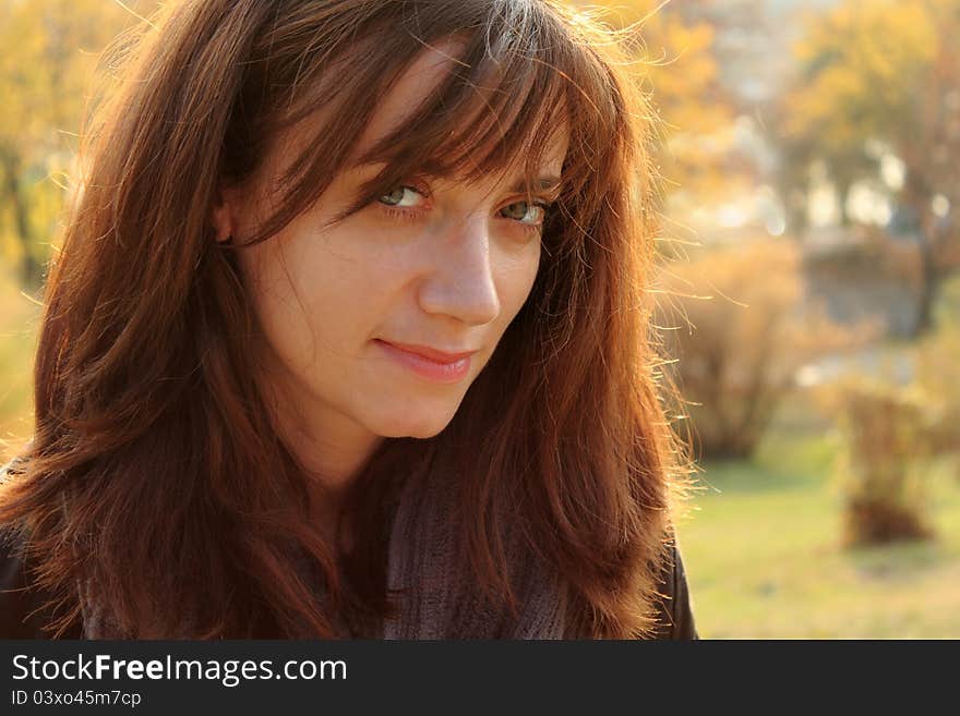 Portrait of a young woman, depicting content and inner happines, taken in the park in the autumn,. Portrait of a young woman, depicting content and inner happines, taken in the park in the autumn,