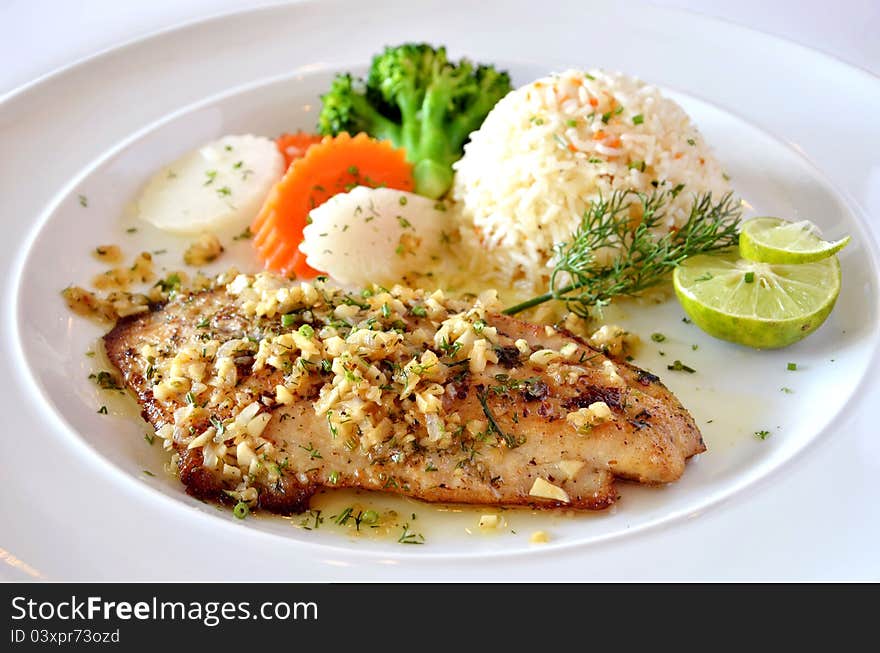 Roasted fish served with fried rice. Roasted fish served with fried rice