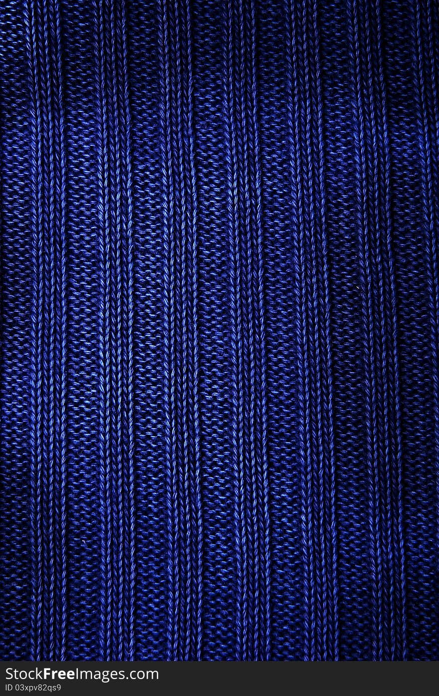 Texture fabric of dark blue color. Vertical