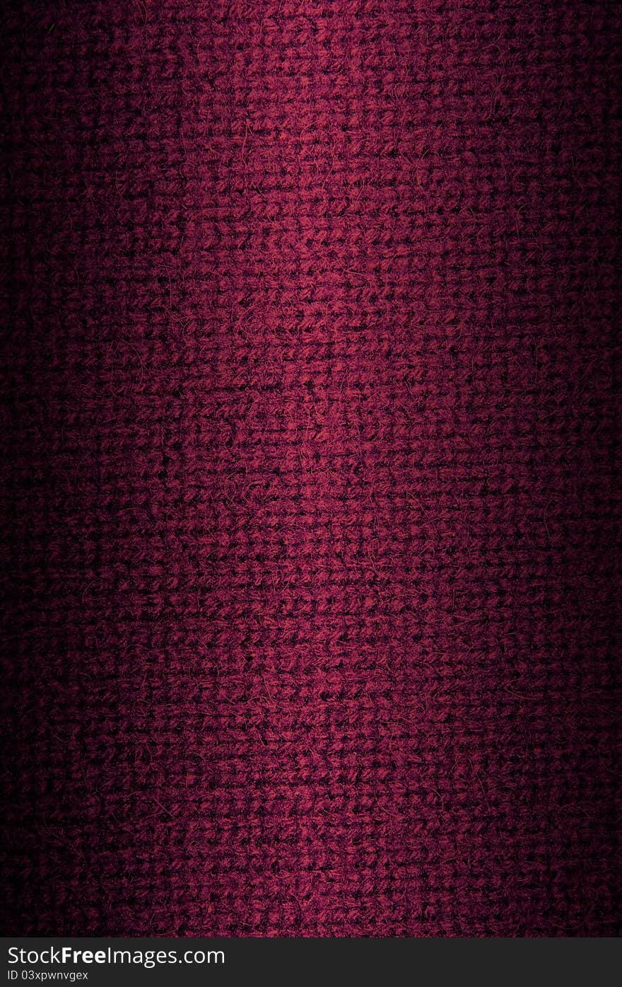 Background a texture a knitted woolen fabric of dark crimson color. Vertical. Background a texture a knitted woolen fabric of dark crimson color. Vertical