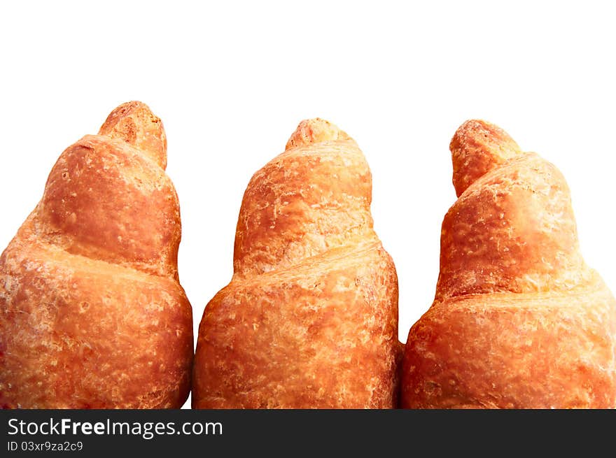 Background three fresh croissants, with a golden crust. Background three fresh croissants, with a golden crust