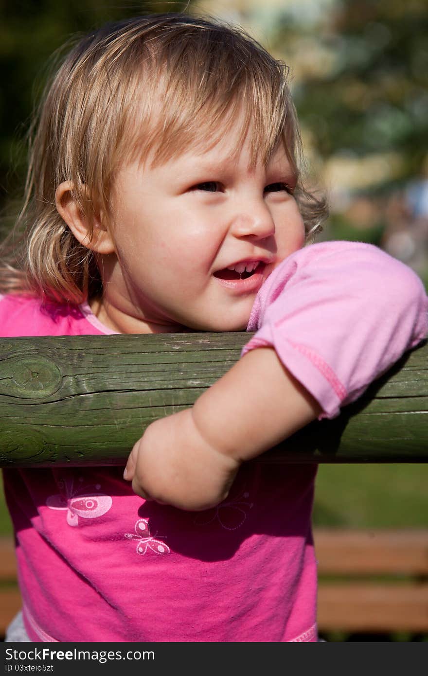 Cute little girl is playing in playground. Cute little girl is playing in playground