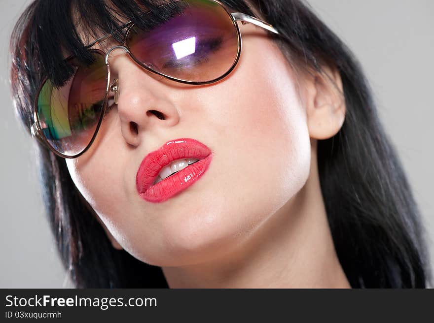 Close-up portrait of sensual and tender woman's face wearing sunglasses. Close-up portrait of sensual and tender woman's face wearing sunglasses