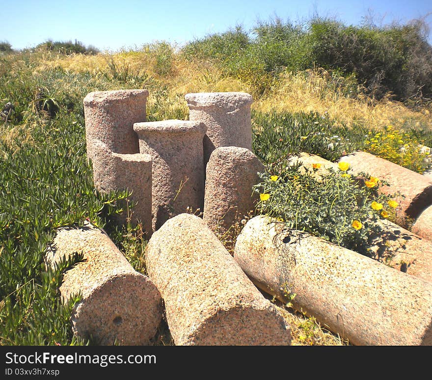 Pile of ancient and weathered sections of Roman columns. In the ruined city of Caesarea, Israel. Pile of ancient and weathered sections of Roman columns. In the ruined city of Caesarea, Israel.