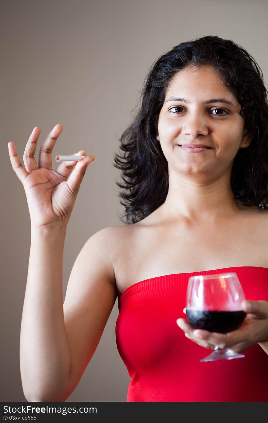 Indian beautiful glamour girl with wine and cigarette. Indian beautiful glamour girl with wine and cigarette