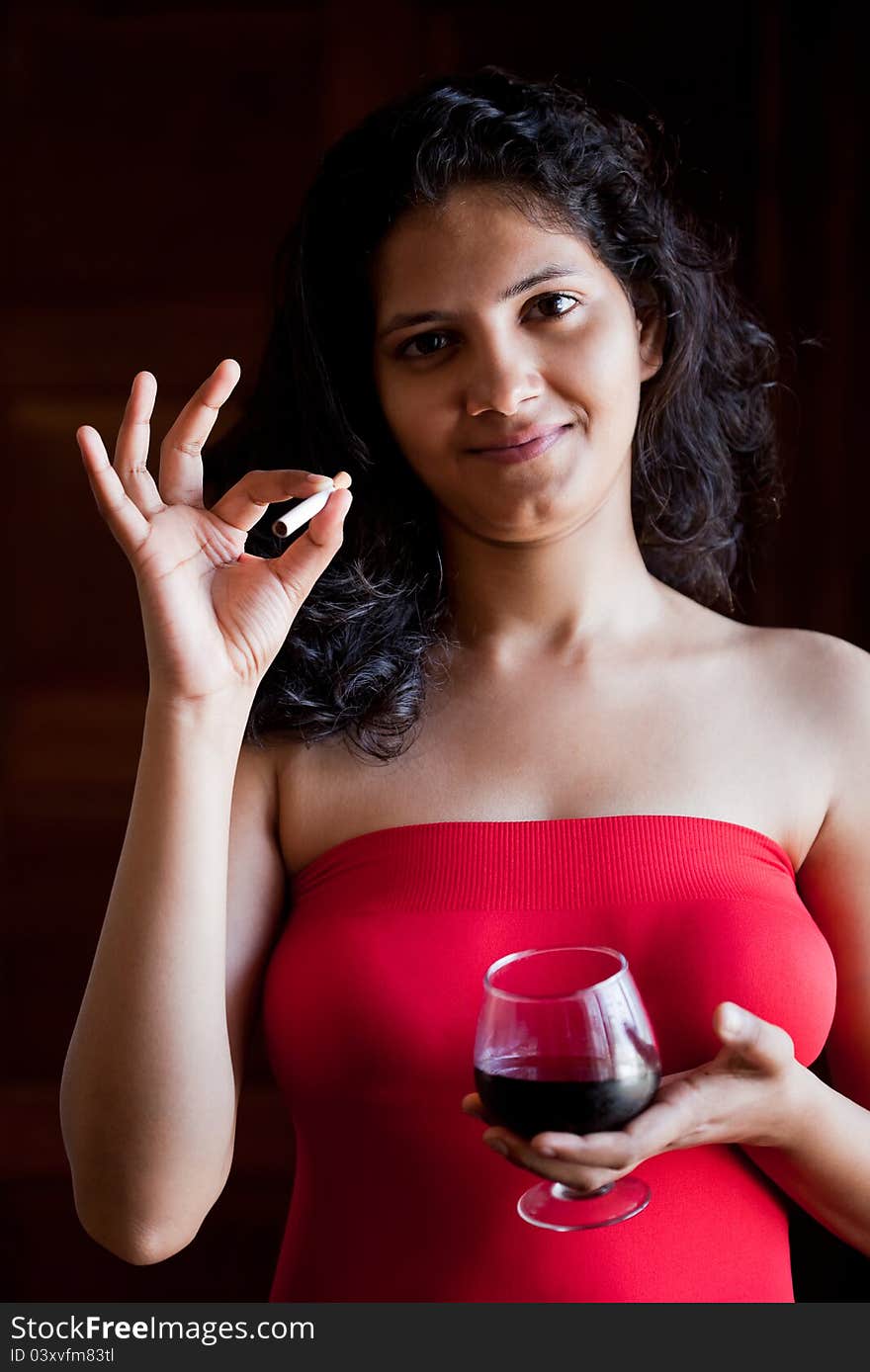 Indian beautiful glamour  girl with wine and cigarette. Indian beautiful glamour  girl with wine and cigarette