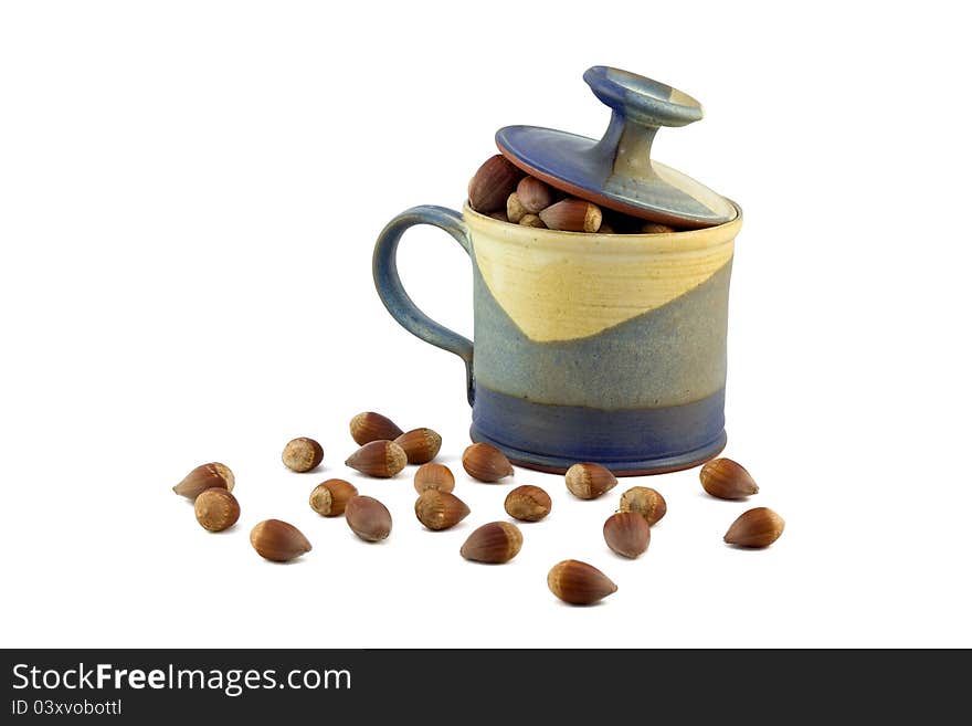 Hazelnut and ceramic mug on white background