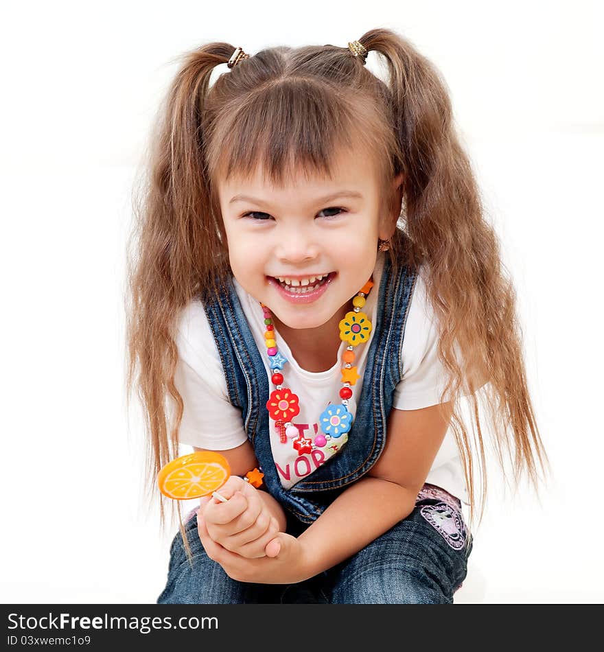 Smiling attractive girl with orange candy on stick isolated on white. Smiling attractive girl with orange candy on stick isolated on white