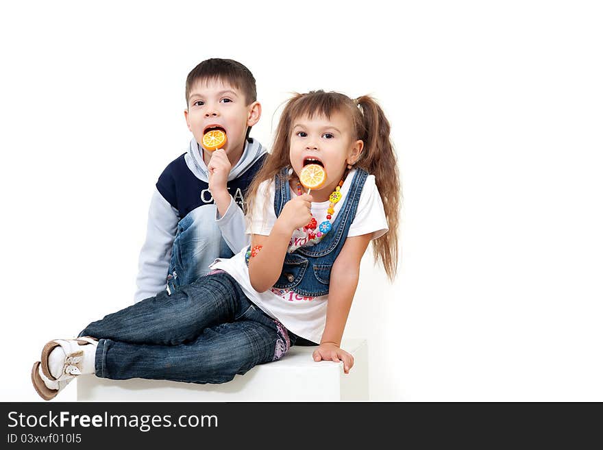 Little Brother And Sister Eating Tasty Candies