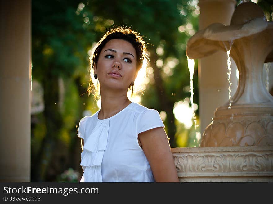 Brunette near the fountain