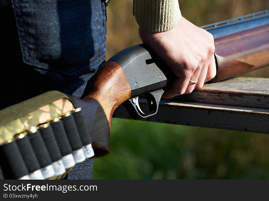 Shotgun with cartridges in hand hunter. Shotgun with cartridges in hand hunter