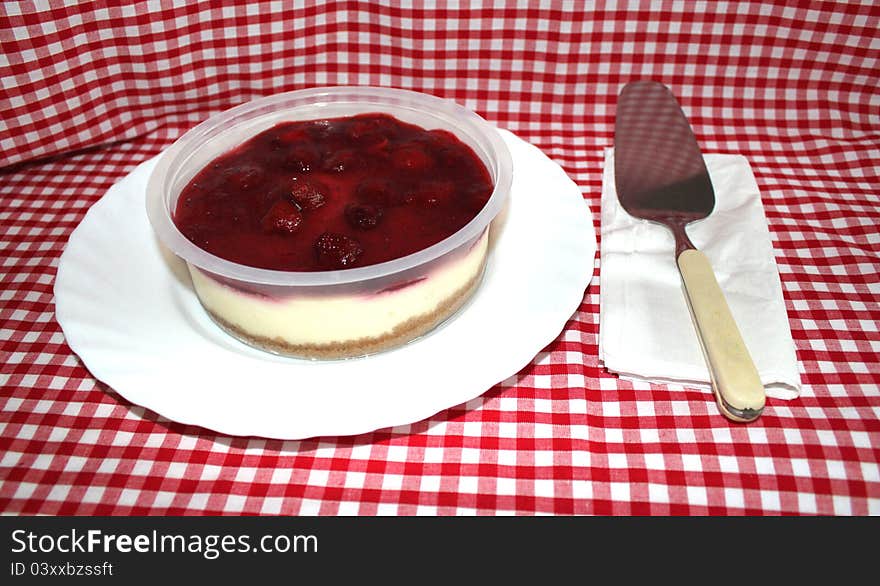 This photo shows a delicious Strawberry Cheesecake just asking to be eaten!. This photo shows a delicious Strawberry Cheesecake just asking to be eaten!