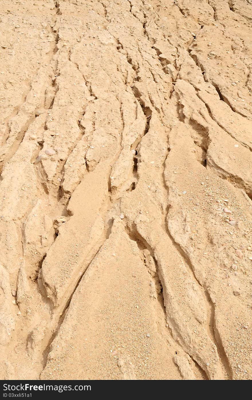 A big pile of sand with furrows at the quarry