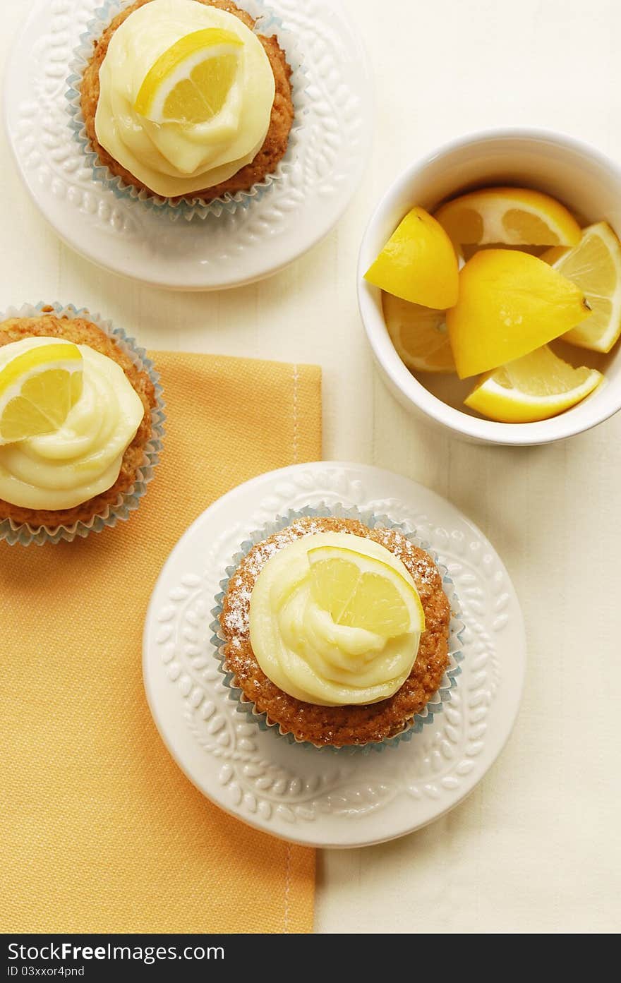 Fresh tasty home-made muffins with lemon curd decorated on white plates