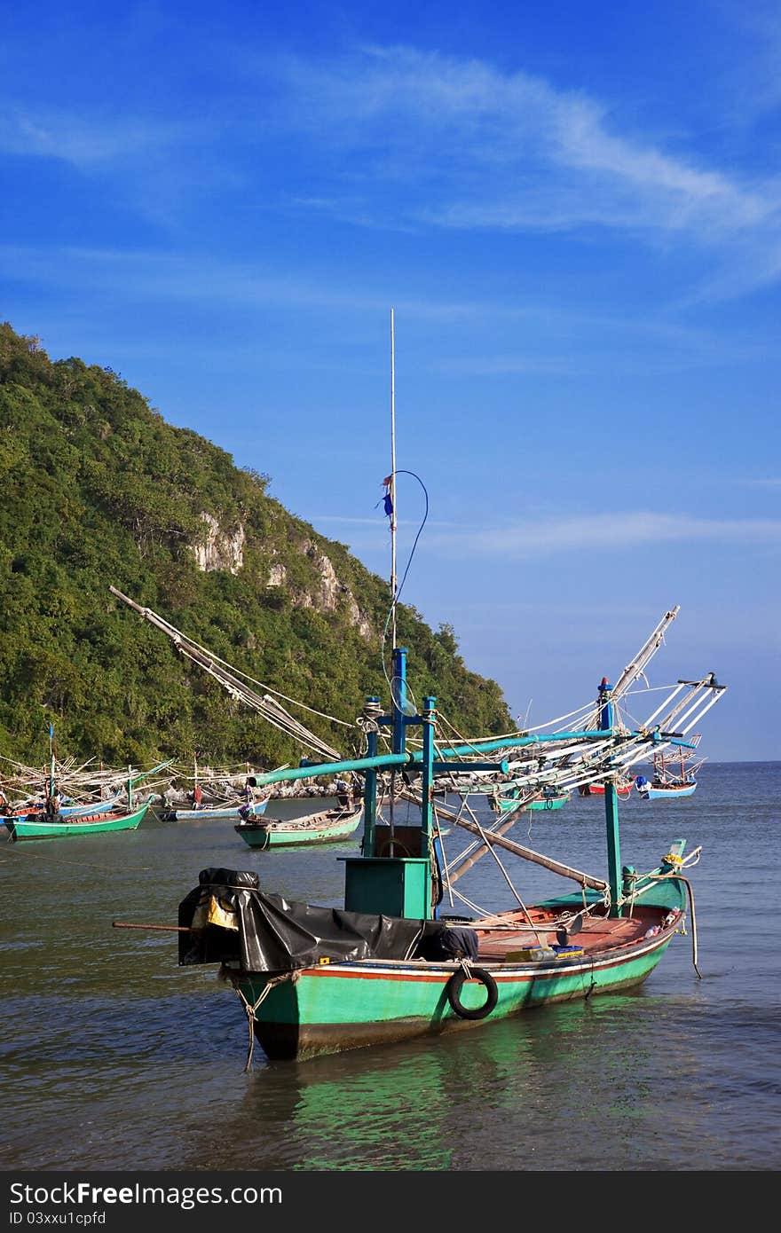 Blue boat in the sand on the beach in Pranburi, Thailand. Blue boat in the sand on the beach in Pranburi, Thailand