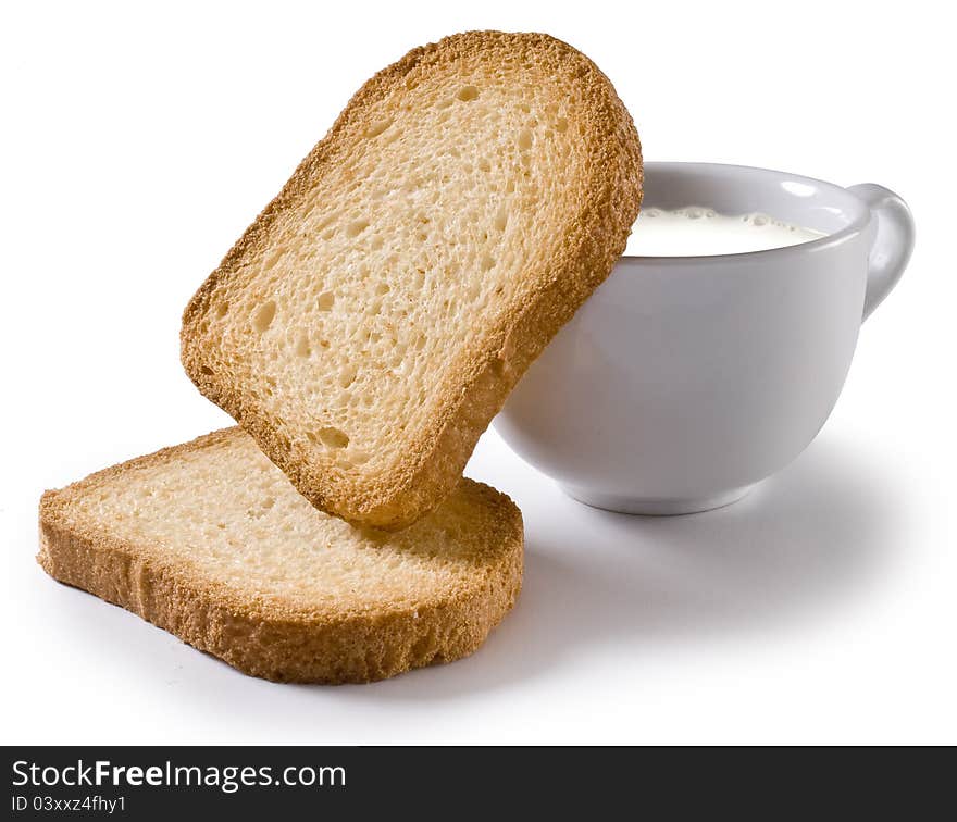 Toasted slices of bread and a cup of milk. Toasted slices of bread and a cup of milk