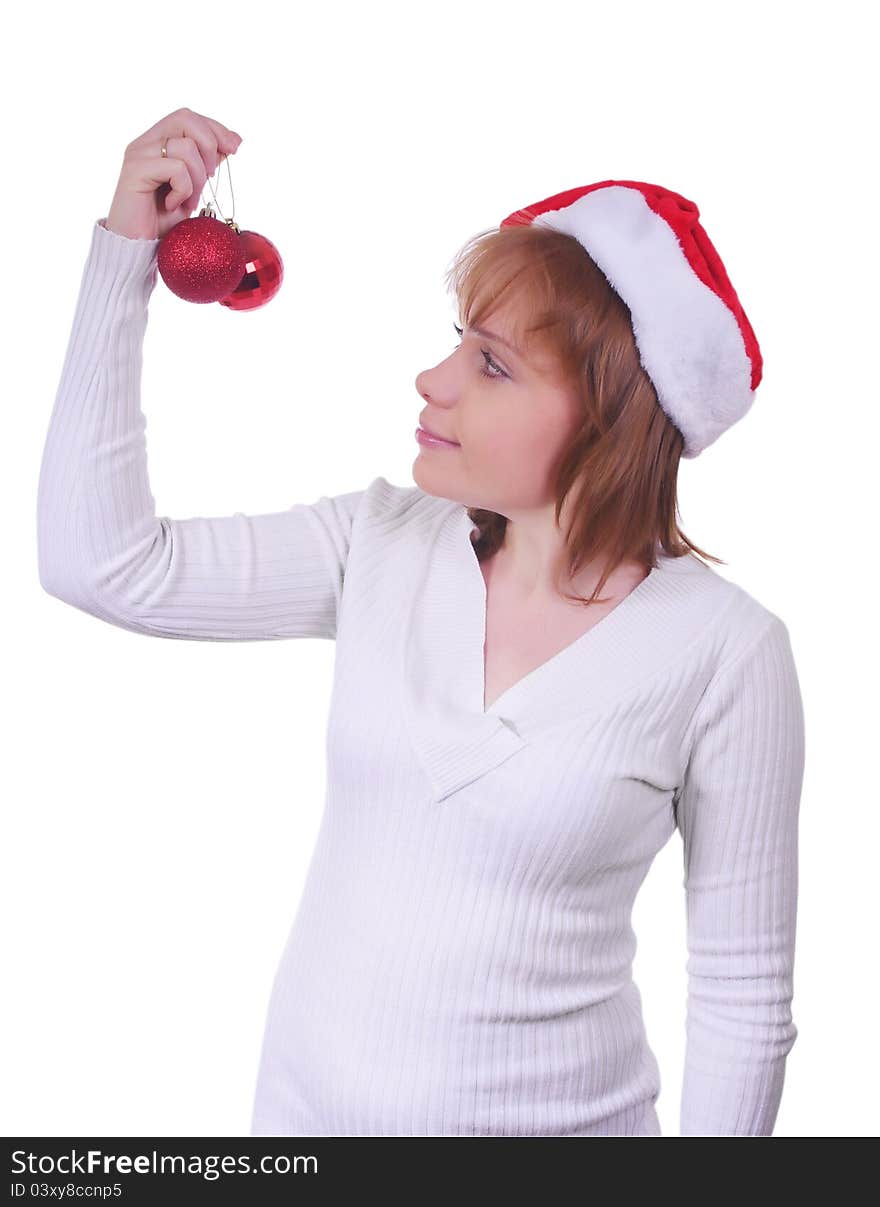 Girl with christmas hat and christmas balls over white. Girl with christmas hat and christmas balls over white