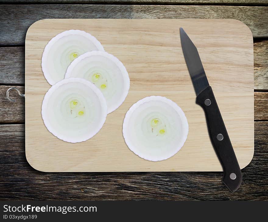 Sliced red onion and knife on chopping board. Sliced red onion and knife on chopping board