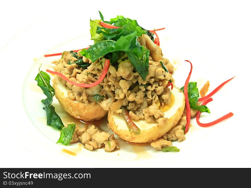 Fried chicken with chili and basil leave on top boiled eggs decorate with deep-fried basil leaves