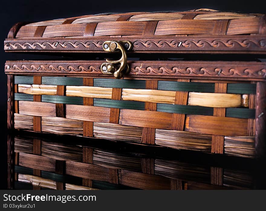 Colorful wooden jewelry box over black background