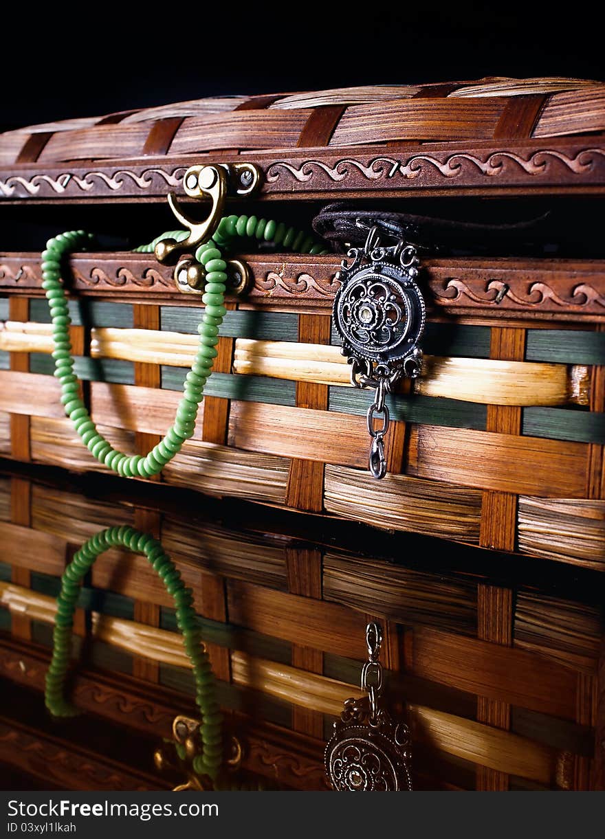 Colorful wooden jewelry box over black background