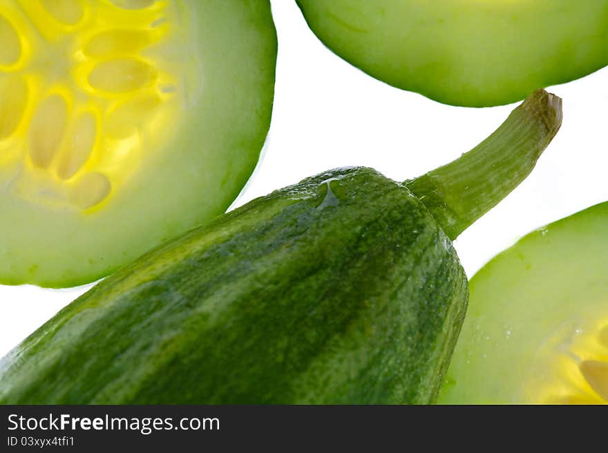 Closeup of cucumber and sliced pieces. Closeup of cucumber and sliced pieces