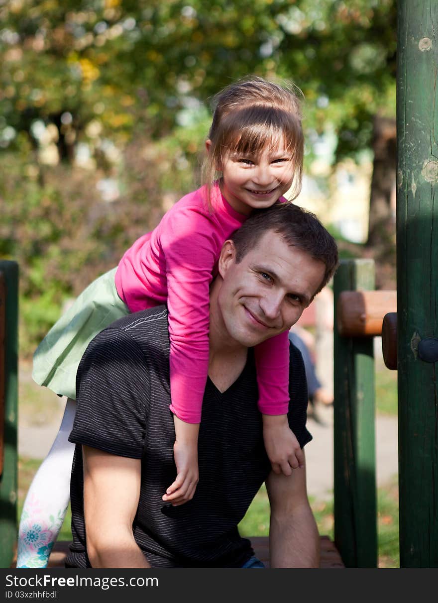 Little girl with her father is spending time at the park. Little girl with her father is spending time at the park.