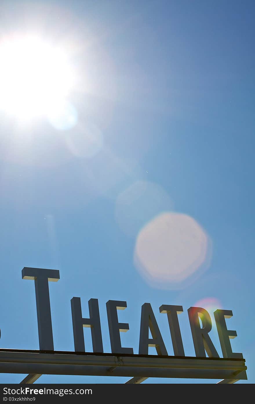 Theater sign below the blue sky and sunlight. Theater sign below the blue sky and sunlight