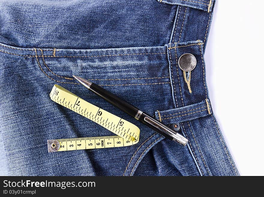 Measuring tape on front blue jeans