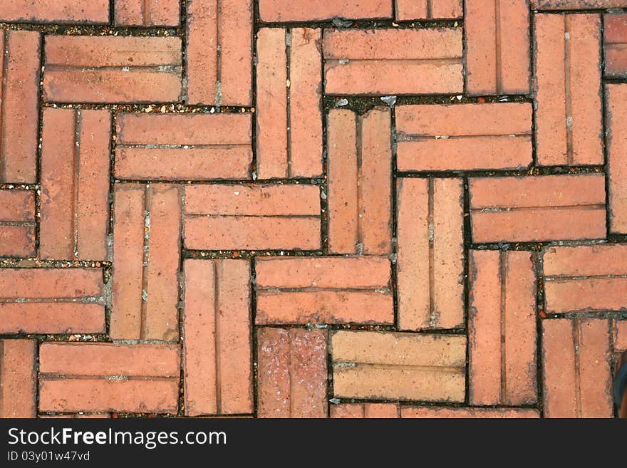 Pattern of Crossing Red Stone pavement, background, Closeup