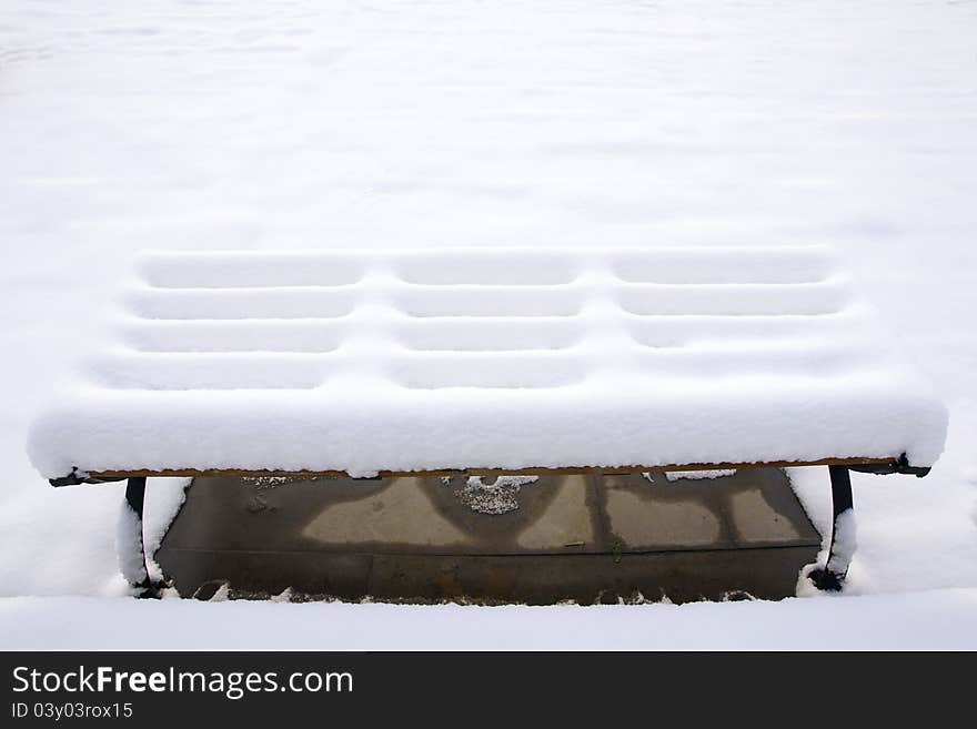 The bench covered with snow. The bench covered with snow