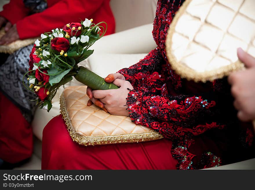 A bride's hand holding a bouquet of flower on wedding day. A bride's hand holding a bouquet of flower on wedding day