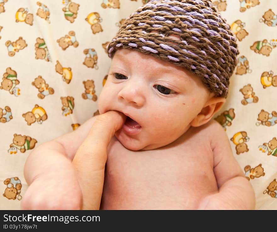 Portrait of a baby girl with teddy bear fabric background.