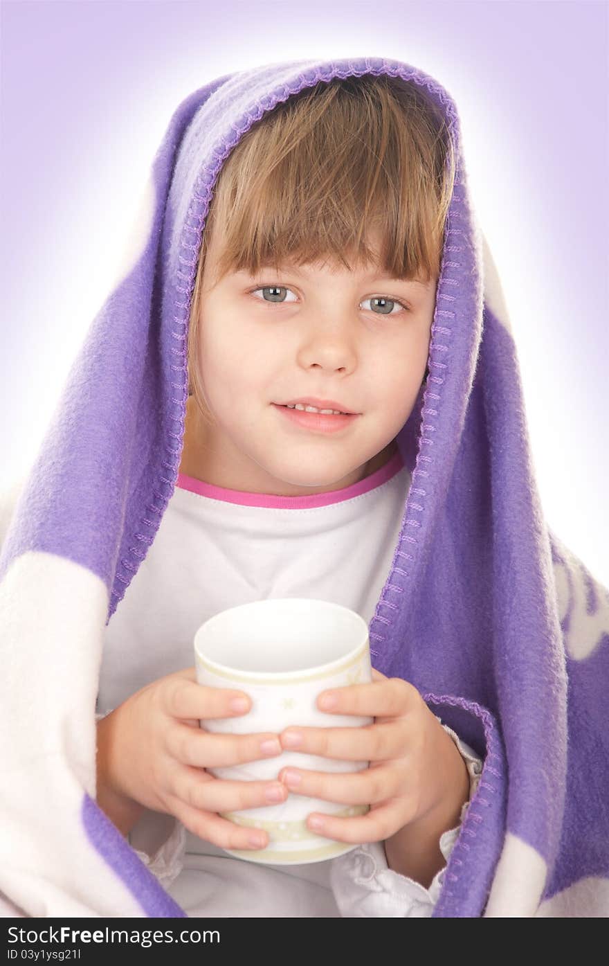 Beautiful little girl with a purple blanket