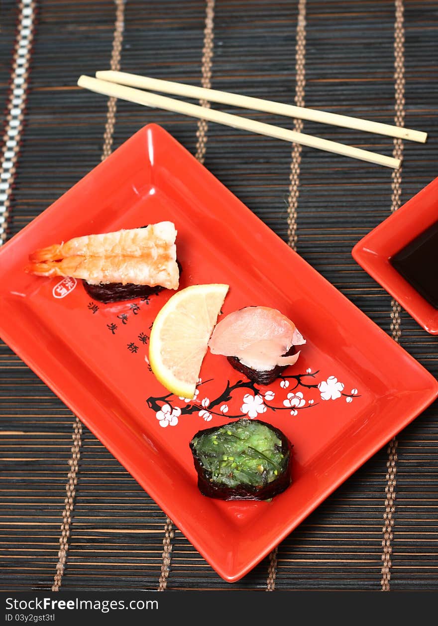 Sushi on a plate with chopsticks