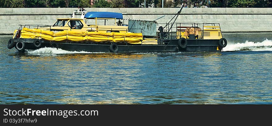 Film- cleaning boat in city. Film- cleaning boat in city